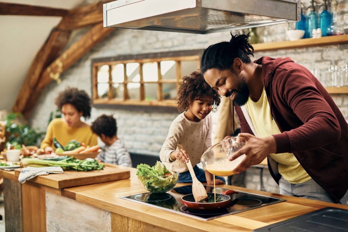 A father cooking breakfast with his daughter